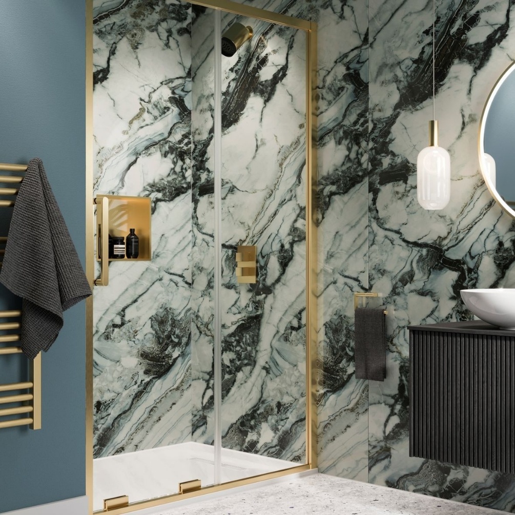 Lifestyle image of the Showerwall Laminate Oyster 2440mm x 900mm Square Cut Hydrocore Wall Panel - SW99 installed in a small bathroom with recessed walk-in shower and brushed brass detailing